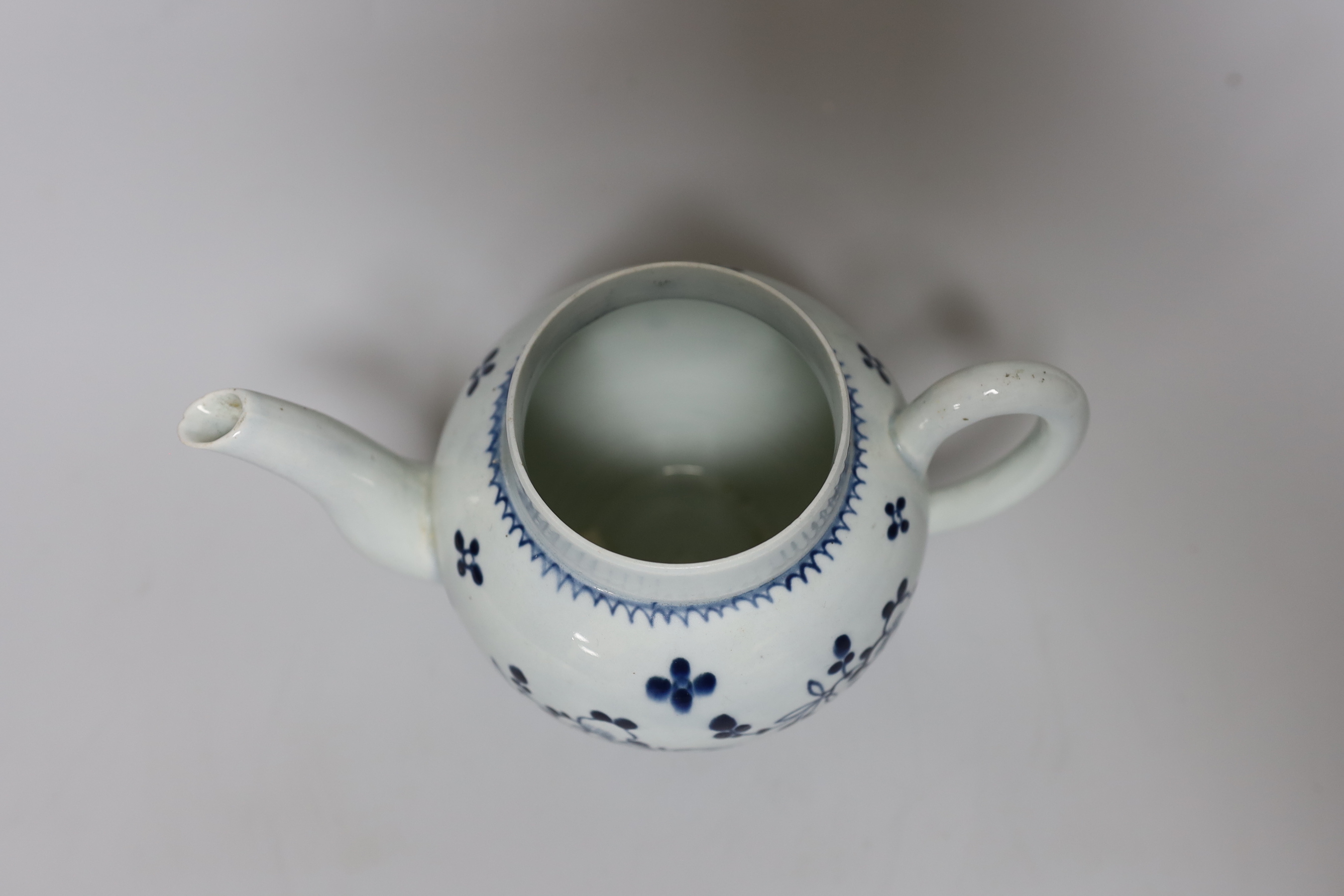 A Liverpool teapot and cover painted with flowers in underglaze blue, c.1775, 15cm tall
